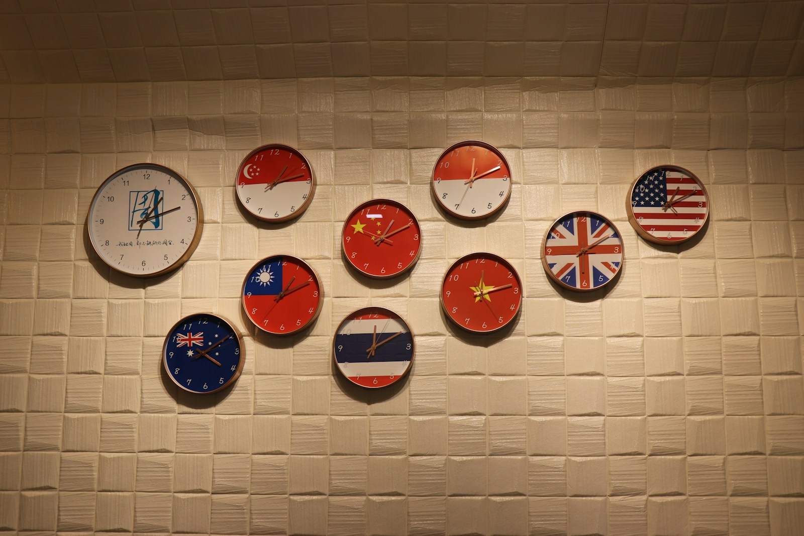 A wall with a bunch of different clocks on it